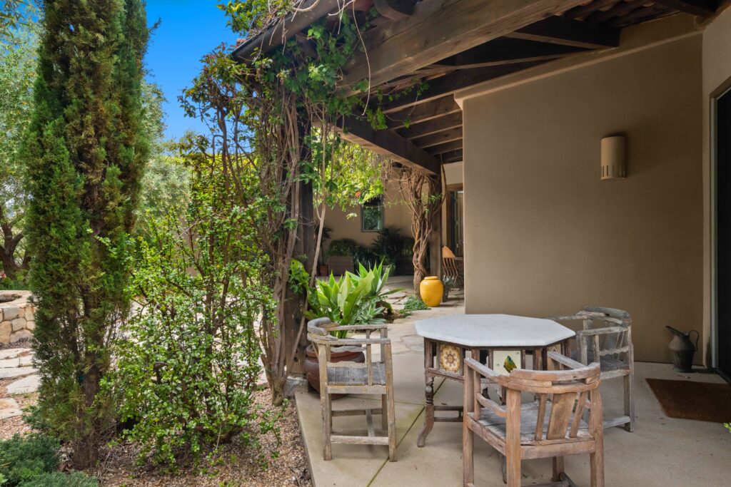 pexels-photo-17086145-17086145 Cozy rustic patio space with vintage furniture and lush greenery